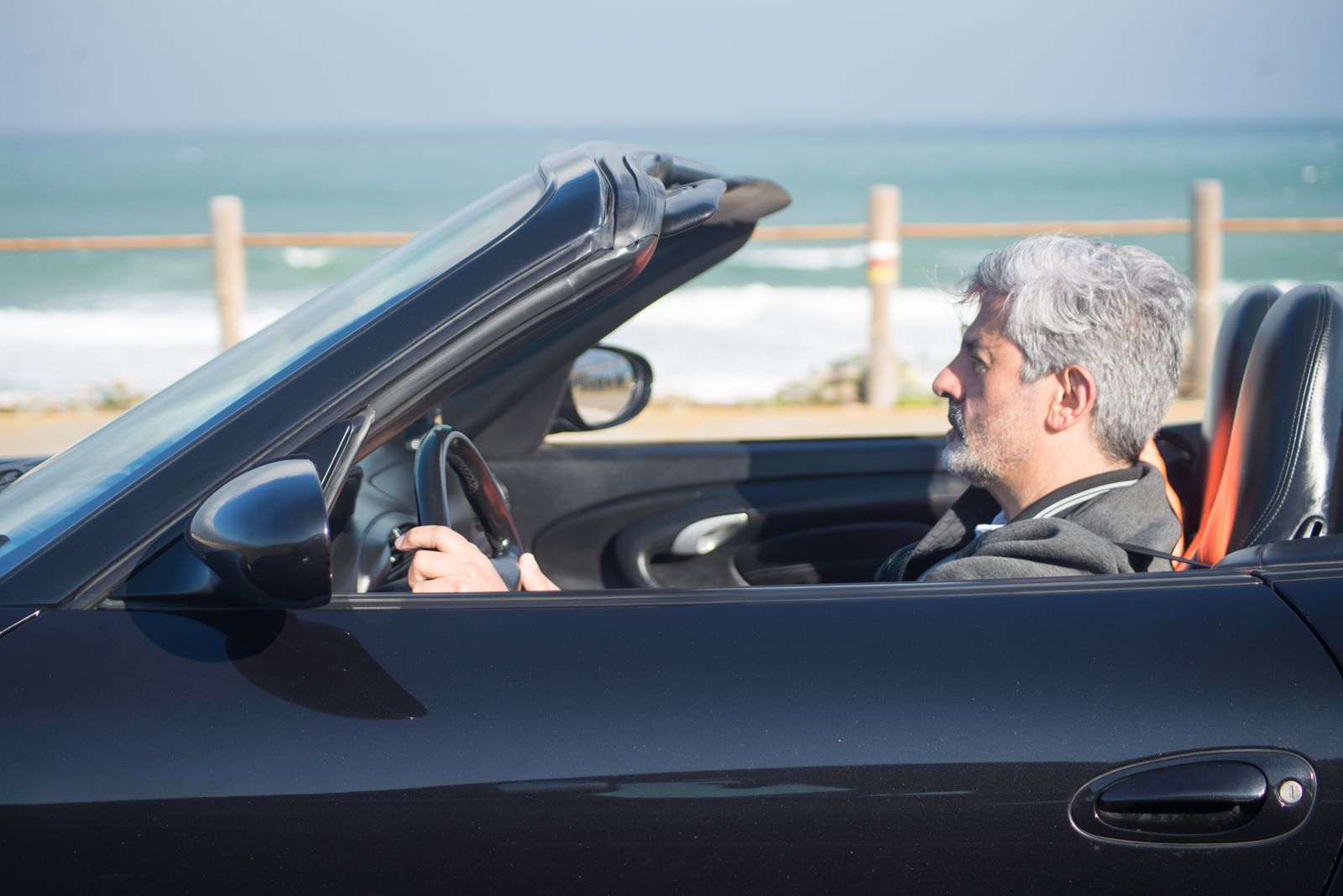 Convertible driving along the Pacific coast